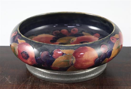 A William Moorcroft pomegranate pattern Tudric pewter mounted bowl, c.1920, 22cm, mount loose